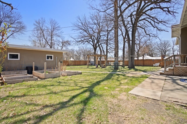 724 3rd Ave, Minot, ND 58703 - view of yard featuring a patio area, an outbuilding, a garden, and a fenced backyard