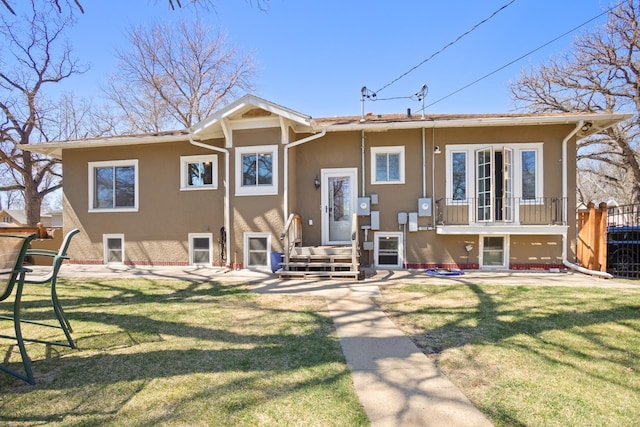 724 3rd Ave, Minot, ND 58703 - back of property with a yard, stucco siding, and fence