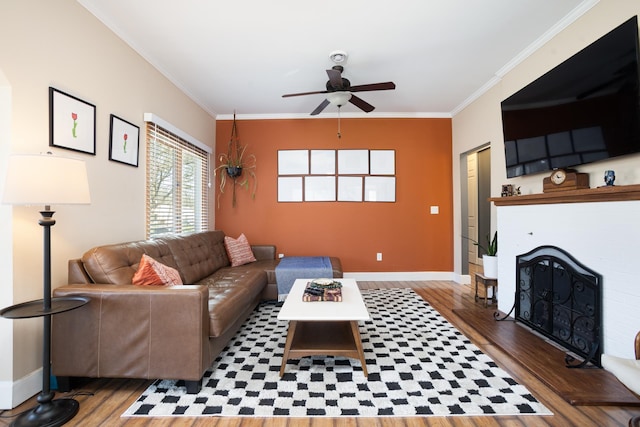 724 3rd Ave, Minot, ND 58703 - living area with ornamental molding, a brick fireplace, wood finished floors, and ceiling fan