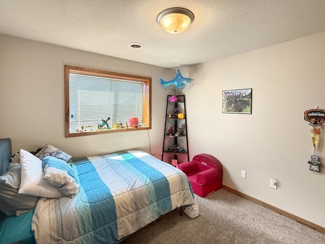 bedroom featuring a textured ceiling, carpet floors, and baseboards
