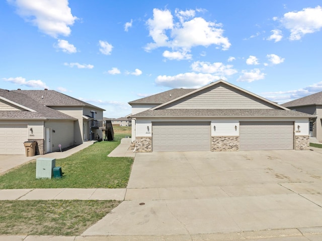 view of front facade featuring concrete driveway, a front yard, brick siding, and an attached garage