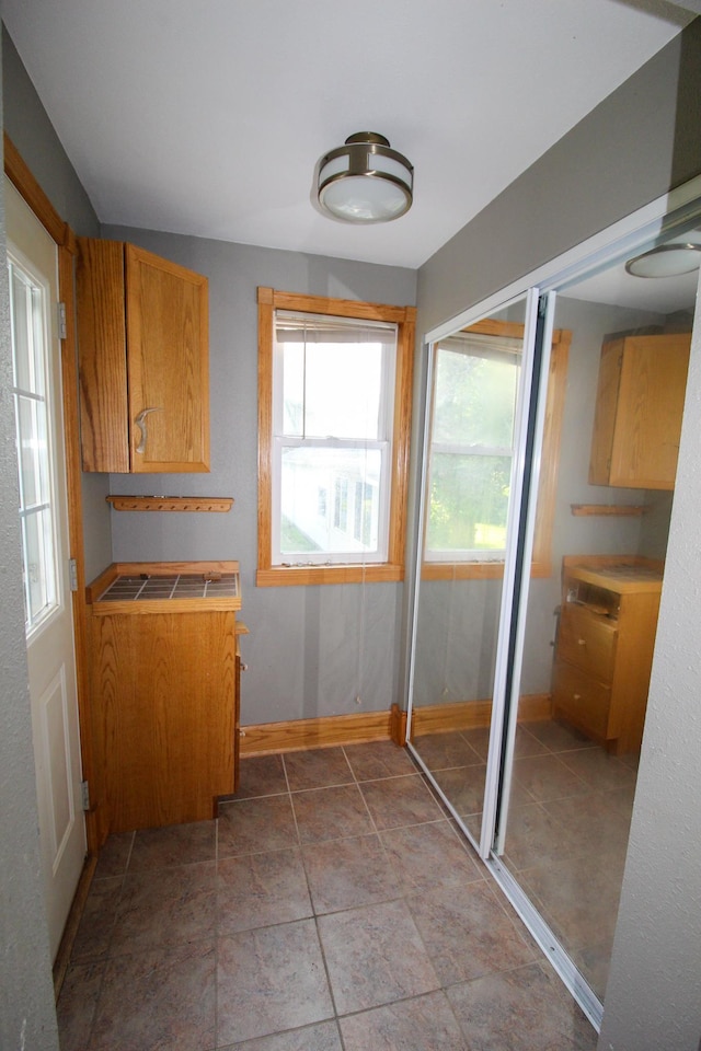 interior space featuring baseboards and a wealth of natural light
