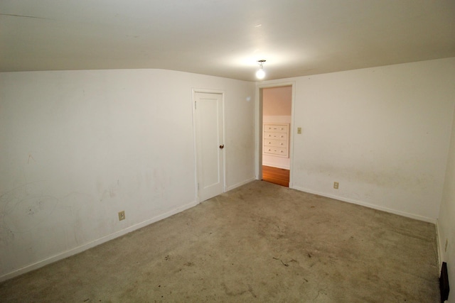 carpeted empty room with baseboards