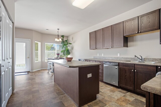 2344 NW 14th St, Minot, ND 58703 - kitchen featuring a center island, a sink, dark brown cabinetry, stainless steel dishwasher, and a chandelier