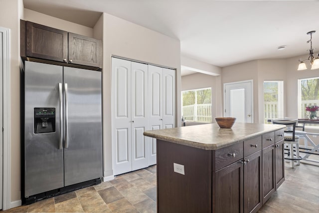 2344 NW 14th St, Minot, ND 58703 - kitchen with dark brown cabinets, a wealth of natural light, stainless steel fridge with ice dispenser, and a center island