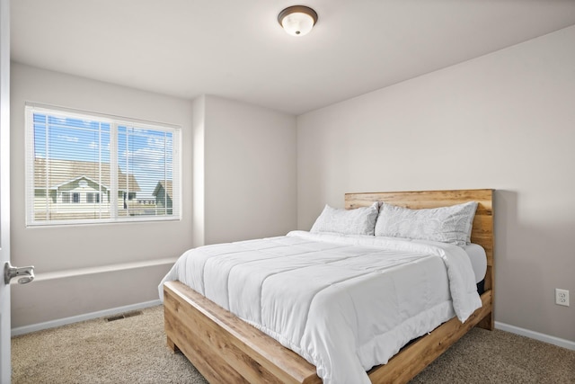 2344 NW 14th St, Minot, ND 58703 - bedroom with carpet, baseboards, and visible vents