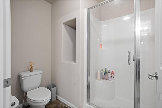 2344 NW 14th St, Minot, ND 58703 - full bathroom featuring toilet, baseboards, and a shower stall