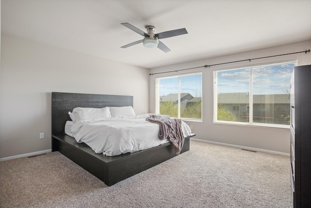 2344 NW 14th St, Minot, ND 58703 - carpeted bedroom with baseboards, ceiling fan, and visible vents