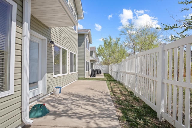2344 NW 14th St, Minot, ND 58703 - view of home's exterior featuring a patio area and a fenced backyard