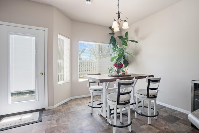 2344 NW 14th St, Minot, ND 58703 - dining room with baseboards, a notable chandelier, and stone finish floor