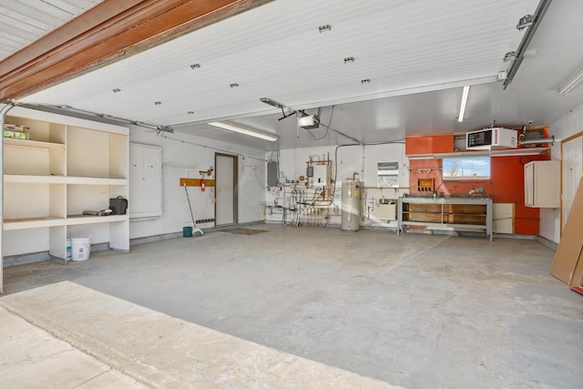600 SW 24th Ave, Minot, ND 58701 - garage with water heater and a garage door opener
