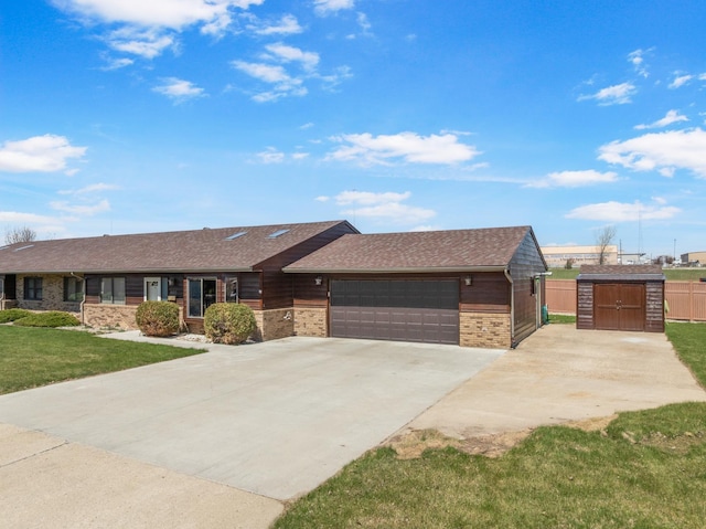 600 SW 24th Ave, Minot, ND 58701 - single story home with fence, brick siding, a storage unit, concrete driveway, and a front yard
