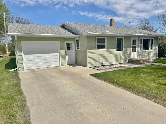 single story home featuring driveway, a chimney, a garage, and a front lawn