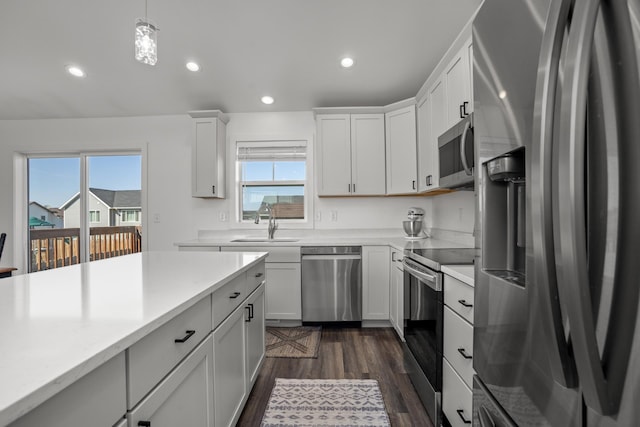 114 Mulberry Loop, Minot, ND 58703 - kitchen featuring appliances with stainless steel finishes, a sink, dark wood finished floors, light countertops, and recessed lighting