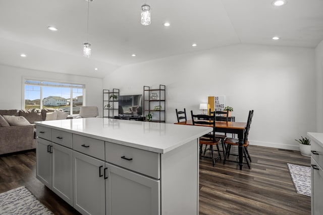 114 Mulberry Loop, Minot, ND 58703 - kitchen featuring vaulted ceiling, open floor plan, dark wood-type flooring, recessed lighting, and light countertops