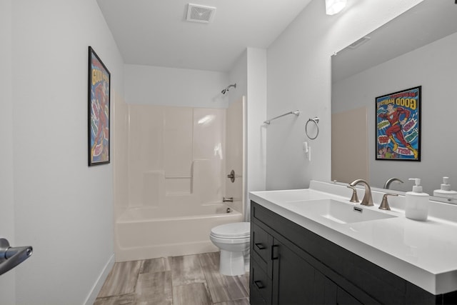 114 Mulberry Loop, Minot, ND 58703 - bathroom featuring toilet, wood finished floors, vanity, and bathtub / shower combination