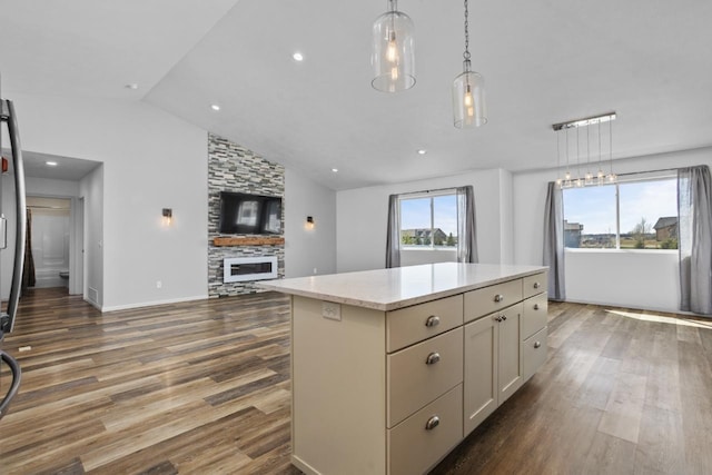1504 Valley Bluffs Dr, Minot, ND 58701 - kitchen featuring open floor plan, dark wood finished floors, lofted ceiling, a kitchen island, and hanging light fixtures