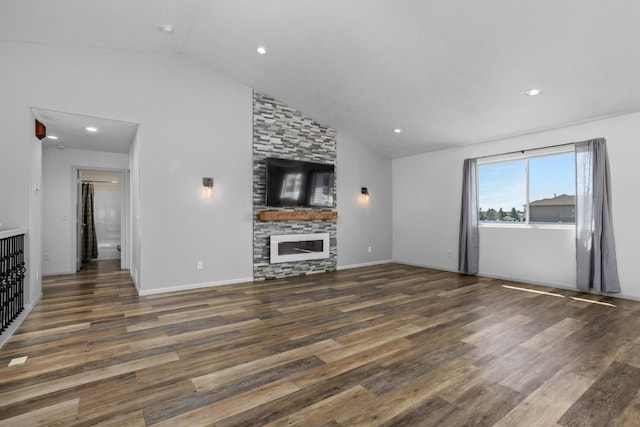 1504 Valley Bluffs Dr, Minot, ND 58701 - unfurnished living room featuring lofted ceiling, wood finished floors, a fireplace, and recessed lighting