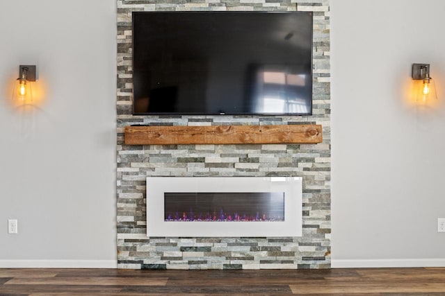 1504 Valley Bluffs Dr, Minot, ND 58701 - detailed view of wood finished floors, baseboards, and a fireplace