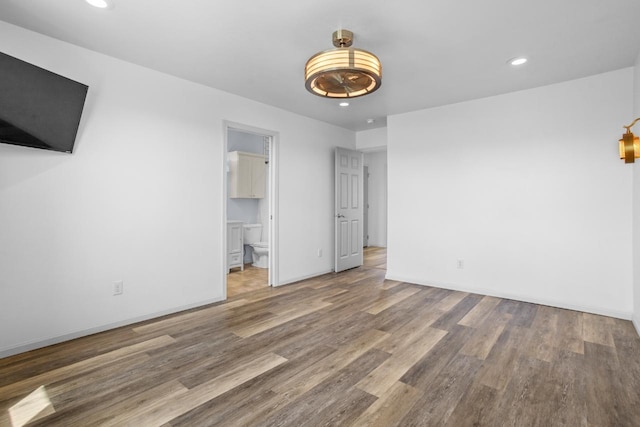 1504 Valley Bluffs Dr, Minot, ND 58701 - spare room with wood finished floors, recessed lighting, and baseboards
