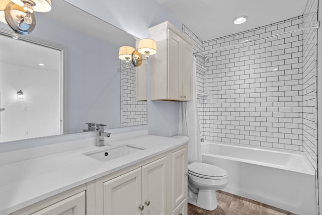 1504 Valley Bluffs Dr, Minot, ND 58701 - full bathroom with toilet, wood finished floors, vanity, shower / bath combo, and recessed lighting