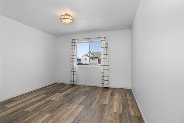 1504 Valley Bluffs Dr, Minot, ND 58701 - unfurnished room featuring wood finished floors and baseboards