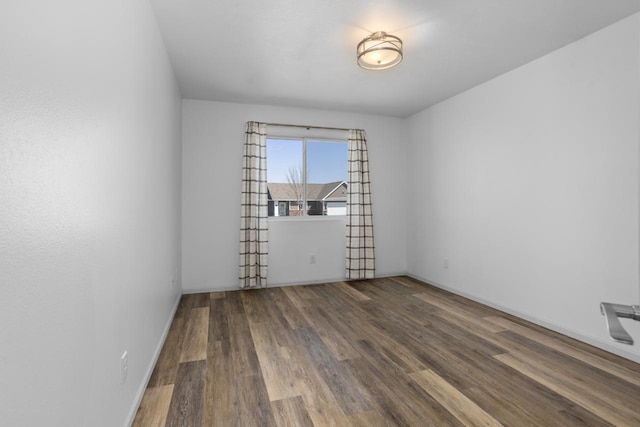 1504 Valley Bluffs Dr, Minot, ND 58701 - empty room with wood finished floors and baseboards