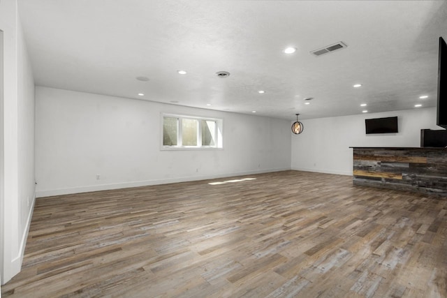 1504 Valley Bluffs Dr, Minot, ND 58701 - unfurnished living room featuring recessed lighting, wood finished floors, and baseboards