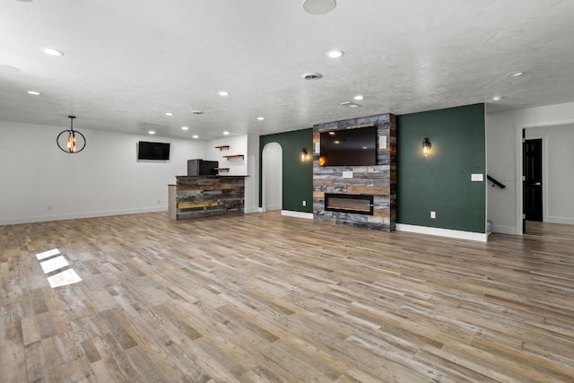 1504 Valley Bluffs Dr, Minot, ND 58701 - living area with recessed lighting, a stone fireplace, wood finished floors, and baseboards