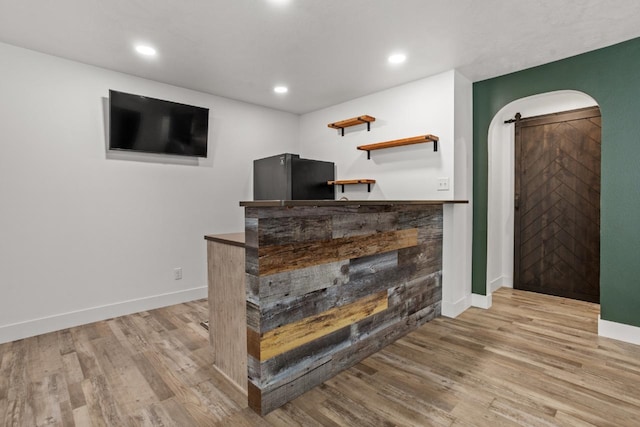 1504 Valley Bluffs Dr, Minot, ND 58701 - bar with wood finished floors, baseboards, a barn door, and recessed lighting