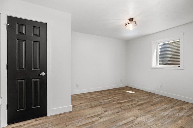 1504 Valley Bluffs Dr, Minot, ND 58701 - spare room featuring baseboards and light wood-style flooring
