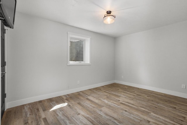 1504 Valley Bluffs Dr, Minot, ND 58701 - unfurnished room with wood finished floors and baseboards