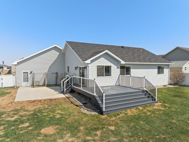 1504 Valley Bluffs Dr, Minot, ND 58701 - back of house featuring a gate, a patio, a wooden deck, and roof with shingles