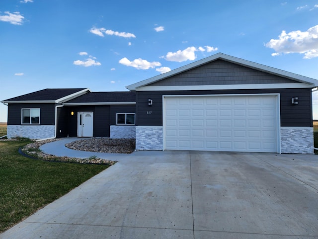 147 Mulberry Loop, Minot, ND 58703 - single story home featuring stone siding, driveway, a front yard, and an attached garage