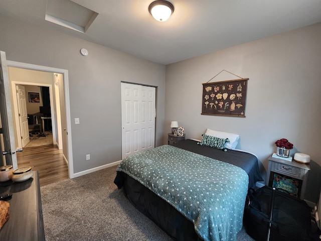 147 Mulberry Loop, Minot, ND 58703 - bedroom featuring attic access, carpet floors, baseboards, and a closet