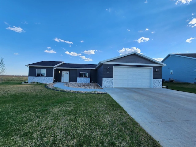 147 Mulberry Loop, Minot, ND 58703 - ranch-style home featuring an attached garage, stone siding, a front lawn, and concrete driveway