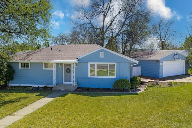 607 16th Ave, Minot, ND 58701 - view of front of home featuring board and batten siding, a front yard, a detached garage, a shingled roof, and an outbuilding