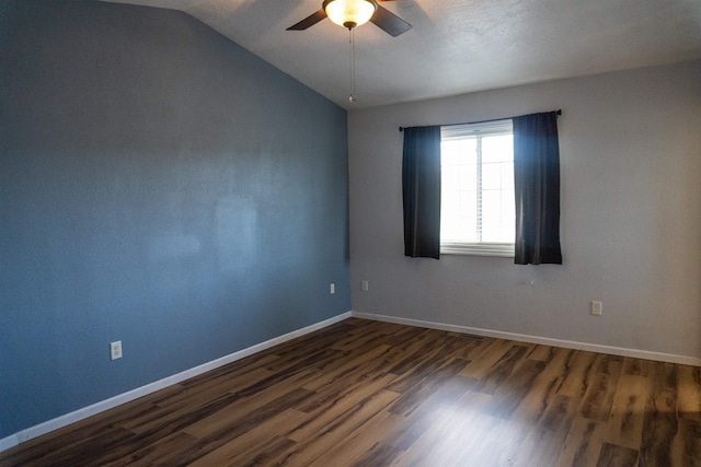 611 16th St, Minot, ND 58701 - unfurnished room featuring a ceiling fan, dark wood-type flooring, lofted ceiling, and baseboards