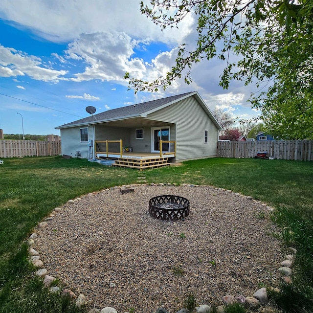 611 16th St, Minot, ND 58701 - back of house featuring an outdoor fire pit and a wooden deck