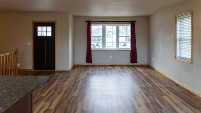 611 16th St, Minot, ND 58701 - entrance foyer featuring wood finished floors and baseboards