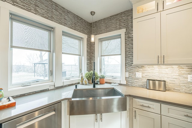 615 2nd St, Garrison, ND 58540 - kitchen featuring a sink, stainless steel dishwasher, decorative light fixtures, and light countertops