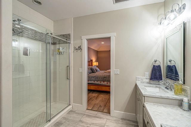 615 2nd St, Garrison, ND 58540 - bathroom with vanity, a shower stall, baseboards, and ensuite bathroom
