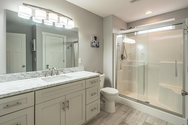 615 2nd St, Garrison, ND 58540 - full bath featuring toilet, a shower stall, vanity, and wood finished floors