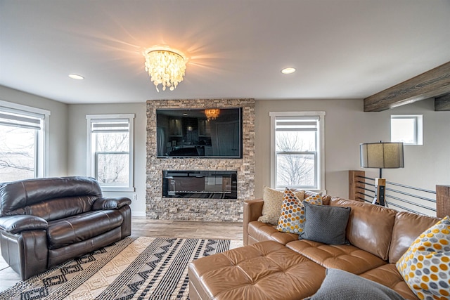 615 2nd St, Garrison, ND 58540 - living area with healthy amount of natural light, recessed lighting, a chandelier, a large fireplace, and wood finished floors