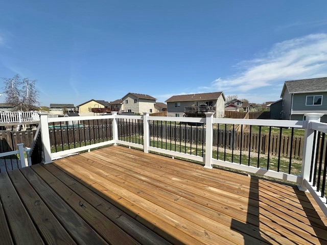 1312 28th St, Minot, ND 58703 - wooden deck featuring a residential view and a fenced backyard