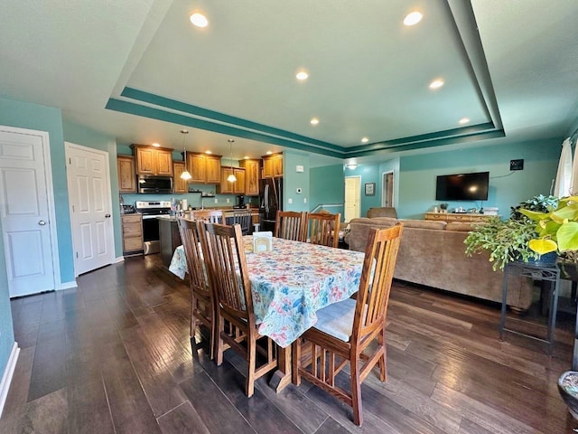 1312 28th St, Minot, ND 58703 - dining space featuring a tray ceiling, dark wood finished floors, baseboards, and recessed lighting
