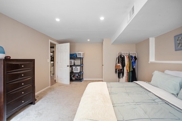 1001 20th St, Minot, ND 58703 - bedroom featuring light carpet, baseboards, recessed lighting, a closet, and a walk in closet