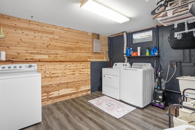 1001 20th St, Minot, ND 58703 - clothes washing area with washer and dryer, wood walls, and wood finished floors
