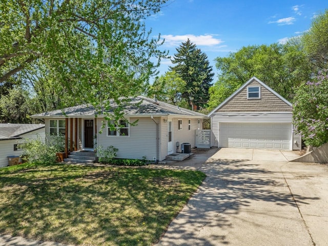 1001 20th St, Minot, ND 58703 - view of front of home featuring a garage, driveway, central air condition unit, and a front lawn