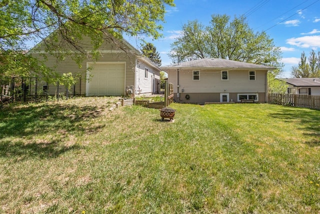 1001 20th St, Minot, ND 58703 - back of property featuring a fire pit and a garage